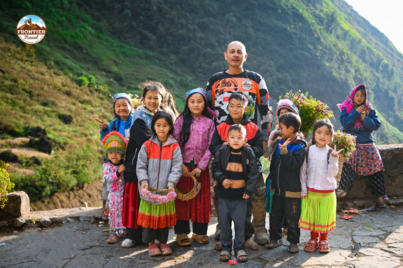 Traveler riding a motorcycle through the northern Vietnam highlands, experiencing mountain wind and local life during cultural travel Vietnam.